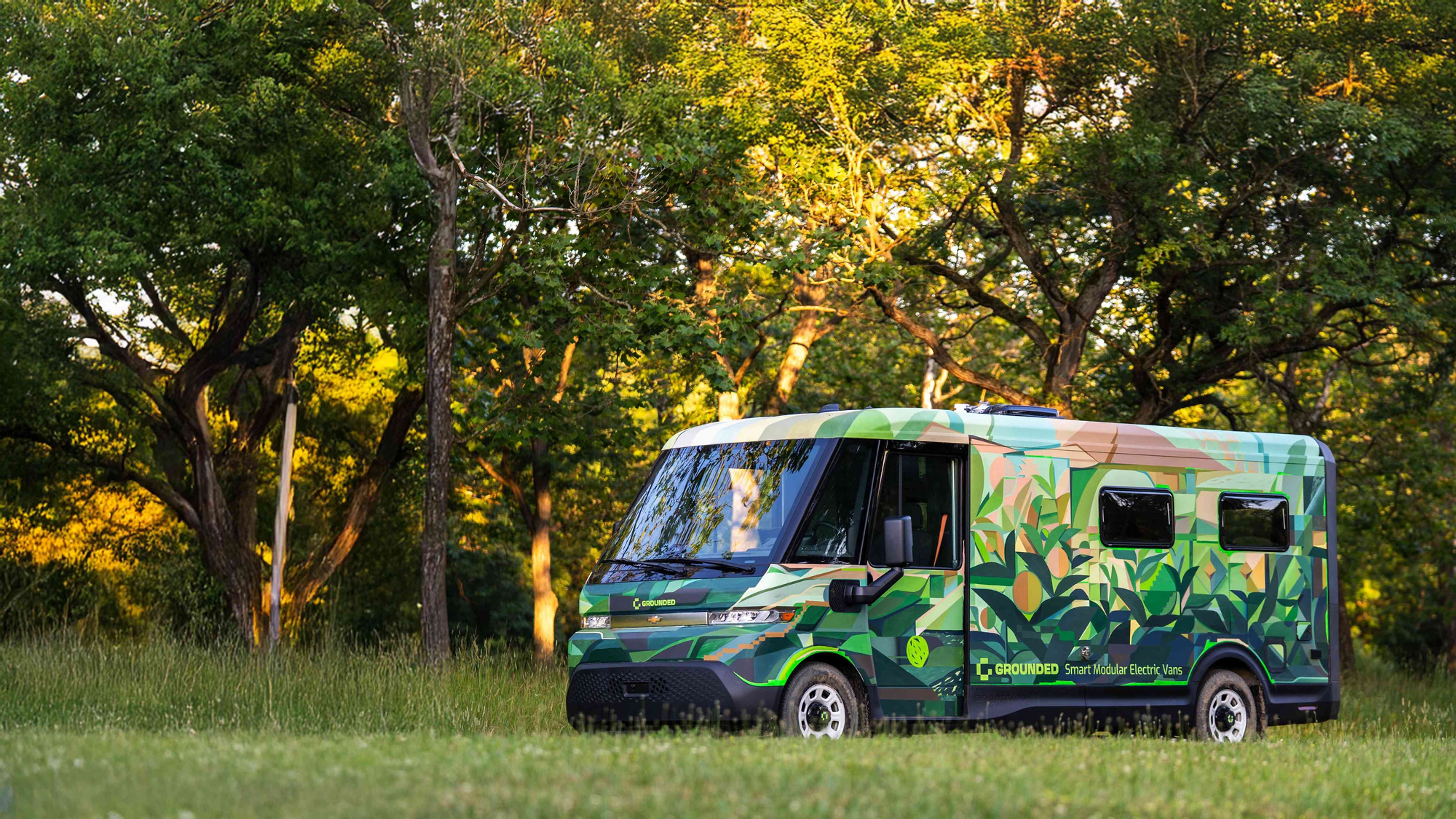 Grounded G3 Electric Camper Van in a lush green field